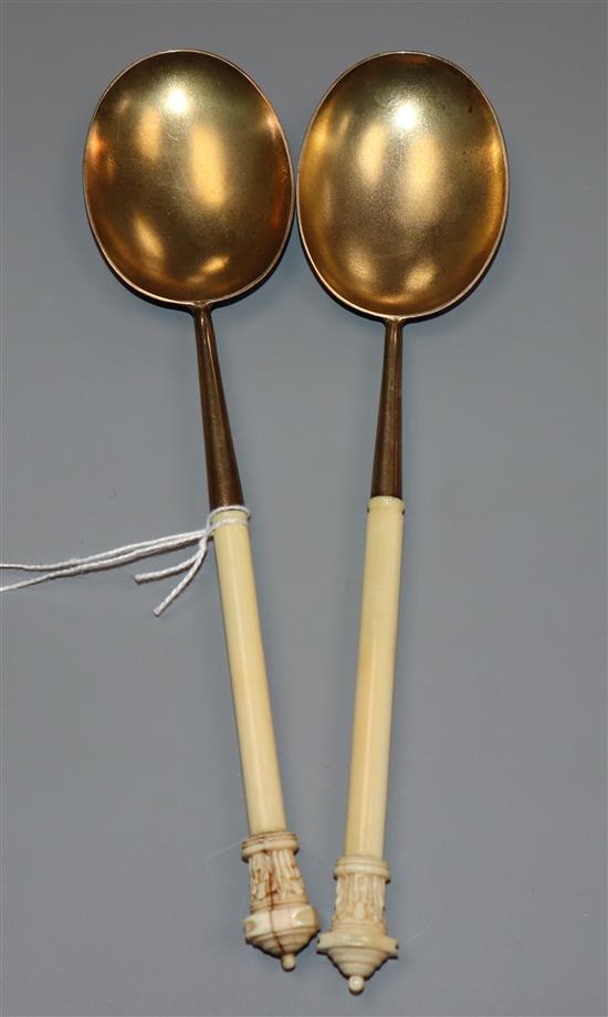 A near pair of Victorian ivory handled silver gilt serving spoons, John Edward Bingham, Sheffield, 1887,